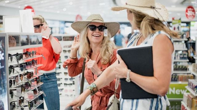 Women trying on hats